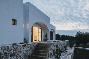 Modern minimalist residential home with a white concrete stone wall