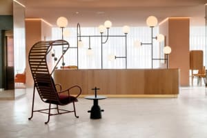 Minimalist reception area with wooden accents and hanging globe lights.
