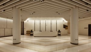 Modern industrial lobby interior with concrete flooring and minimalist design.