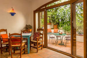 A cozy dining room with wooden furniture and a terrazzo table