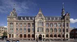 Classical stone and brick building with multiple floors and windows.