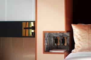 Close-up of a modern bedroom featuring a metal accent wall.