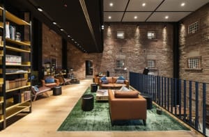 Modern lobby with brick walls, featuring contemporary furniture and minimalist design.