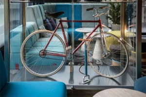 A minimalist office space featuring a metallic bicycle on display.