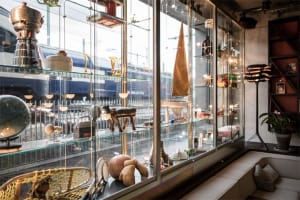 A retail shop interior featuring glass shelves with various decorative objects.