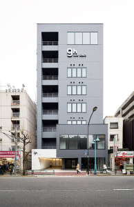 Modern gray concrete building with a minimalist design.
