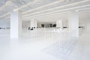 An empty minimalist office space with white flooring and walls.
