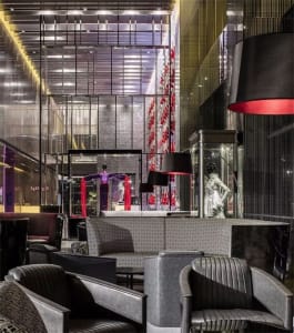 A modern retail storefront featuring metallic furniture and illuminated signage.