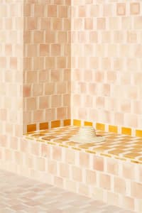 A minimalist interior space with tiled flooring and walls.