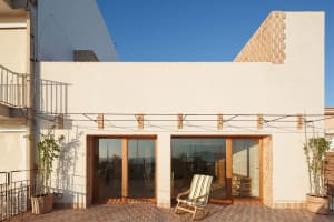 Modern building exterior featuring brick, glass, and terracotta materials.