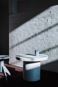 A minimalist interior design featuring marble and concrete materials.