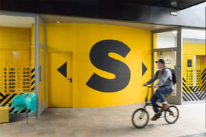 A modern street entrance with bright yellow paint.