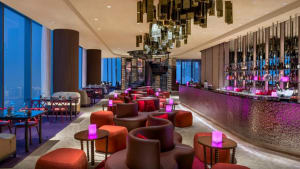 A modern restaurant bar with contemporary design elements and illuminated seating areas.