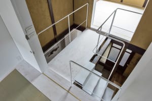 An industrial-style staircase with metal railings and concrete flooring.