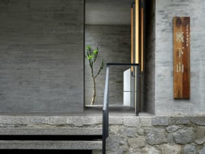 Concrete and stone entrance with minimalist design elements.