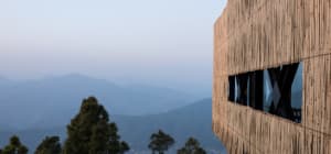 A modern building exterior made of bamboo with a unique architectural design.