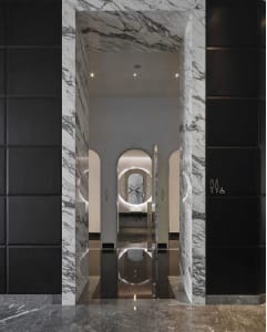 A modern interior space featuring marble materials and minimalist design elements.