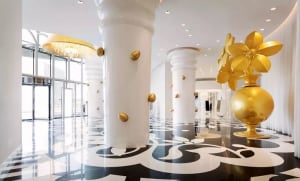 Modern interior with gold metallic decorations and white columns