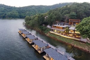 Floating Resort with Modern Architectural Design, Concrete Roofs, and Wooden Structure on Waterfront Location