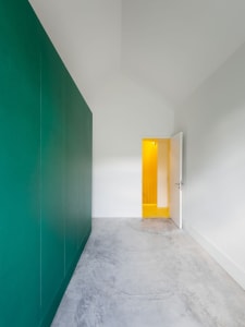 A modern minimalist interior featuring concrete walls and floors.