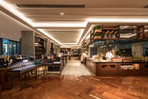 A modern restaurant interior featuring a wooden floor and minimalist design.