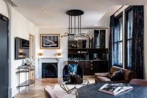 A modern living room featuring marble flooring and furniture.