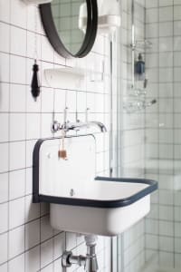 A minimalist bathroom with ceramic tile and glass features.