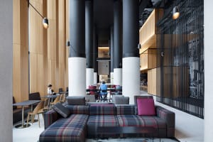 A modern office space featuring a combination of wood, glass, and metal materials.
