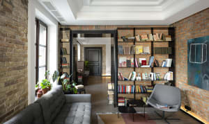 Industrial-style living room with exposed brick walls and modern furniture.