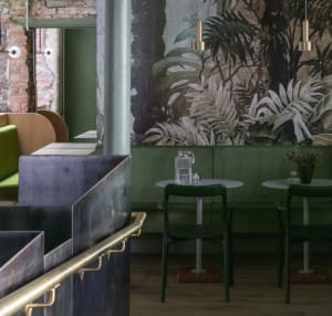 A modern industrial restaurant interior with concrete and leather materials.