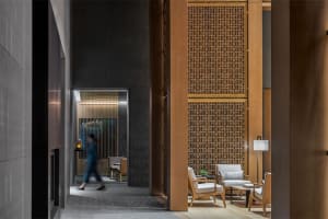 A modern lobby featuring wooden paneling and contemporary furniture.