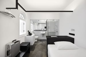 a modern minimalist bedroom with white walls and black accents
