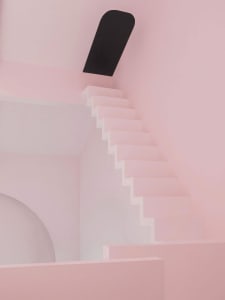 Modern architectural staircase made of pink plaster with a black wall feature.