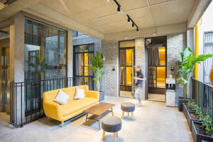 A modern industrial living space with concrete and brick elements.