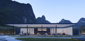 A minimalist outdoor lounge area with metal, glass, and wooden elements.