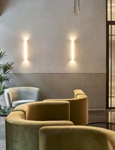 Luxurious living room featuring modern design with plush velvet couches, minimalist decor, and soft lighting.