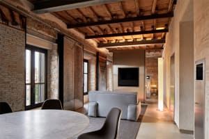 A modern interior space with exposed concrete walls and floors, and a minimalist design.