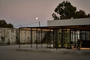 A minimalist residential structure with a concrete facade and a modern architectural design.