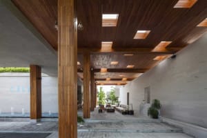 Modern hotel lobby featuring concrete and cedar plank flooring and a skylight ceiling