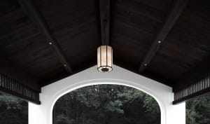 A beautifully designed wooden ceiling with a lantern hanging from it, providing warm lighting.