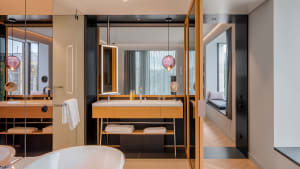 Modern bathroom with wooden furnishings and concrete walls