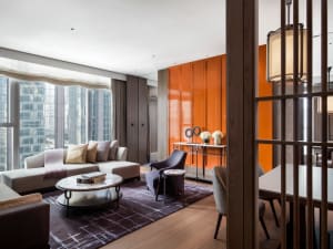 Modern living room with retro furniture, including wood and metal finishes.