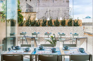 Modern restaurant interior featuring metal, glass, and concrete elements.