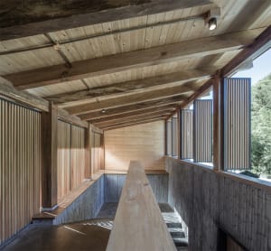A modern interior space featuring wood paneling walls and ceiling.