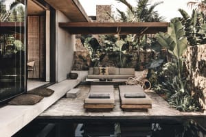 Outdoor patio with modern minimalist design featuring concrete and stone materials.