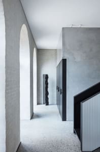A modern interior space featuring concrete walls and floors.