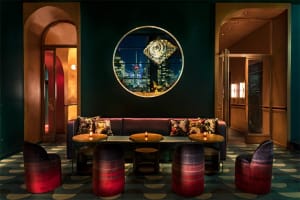 Industrial-style restaurant bar featuring metal, glass, and fabric elements.