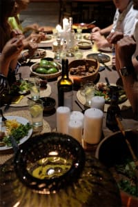 A modern dining room with a wooden table, chairs, and various food items on the table.