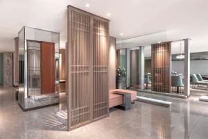 Modern lobby featuring glass panels and ambient lighting.