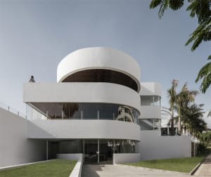 A modern residential building with glass and concrete exterior materials.